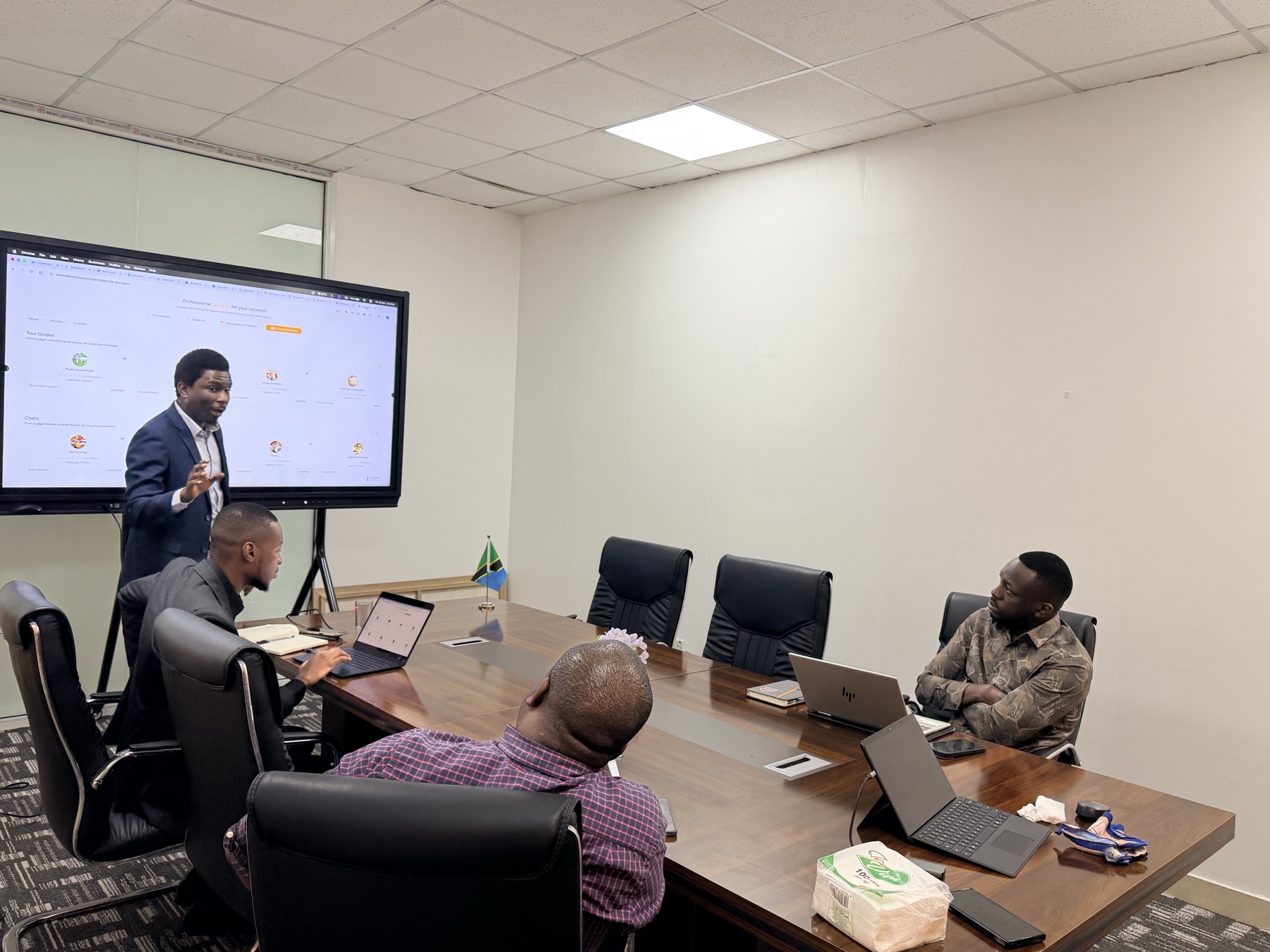 Facilitator addressing participants around a boardroom table